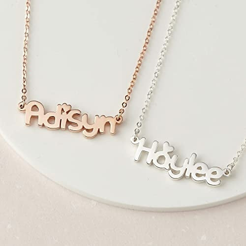 Two name necklaces, one in rose gold and the other in silver, on a white surface.