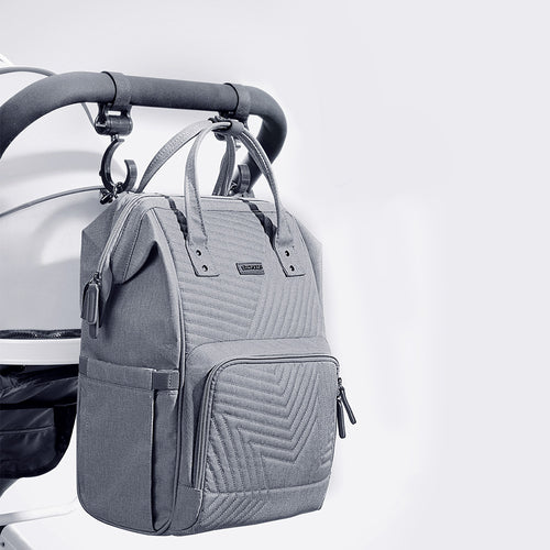 Gray quilted backpack attached to a stroller on a light gray background