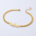 Gold chain bracelet with 'Kaitlyn' engraved on a light gray background