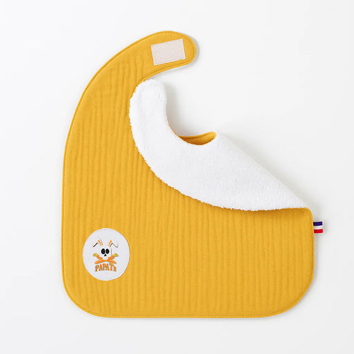 Yellow baby bib with white interior and a logo on a white background